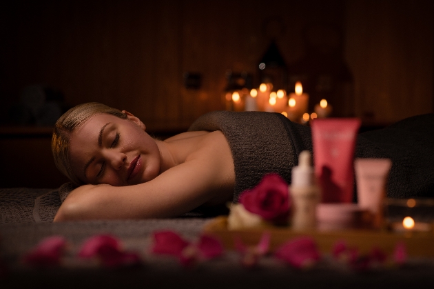 Woman in a treatment room covered in towel ready for massage