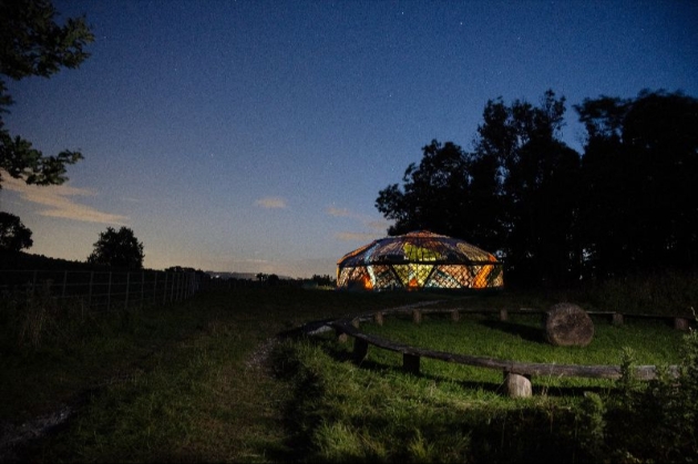 Yurt at Broughton Sanctuary illuminated in the darkness